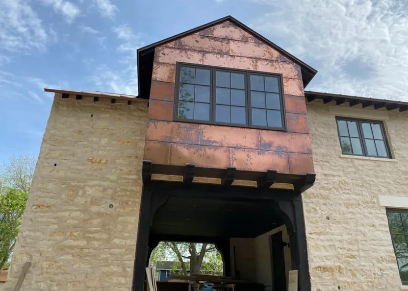 Copper metal panel facade on a stone building for Metal Roof Coating in Wylie