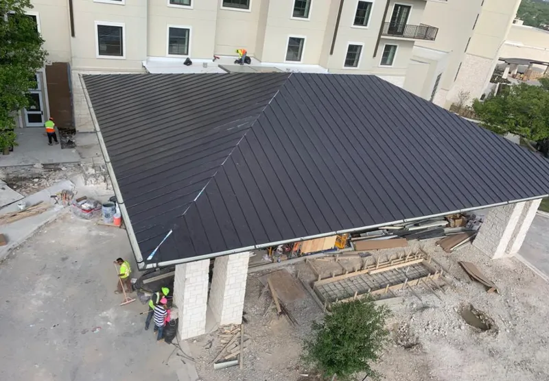 Metal roofing installation team working on a commercial building in Wylie